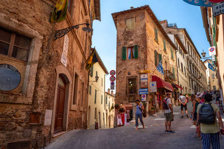 Montepulciano, Tuscany, Italy. August 2020. Stunning urban landscape with the main street rising to the top of the hill of the historic village. People on the street, beautiful summer day.のeditorial素材