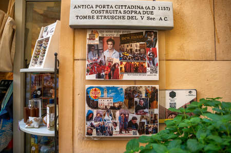 Montepulciano, Tuscany, Italy. August 2020. Next to a shop window an information sign reminding that scenes from a well-known fantasy film were shot here.のeditorial素材