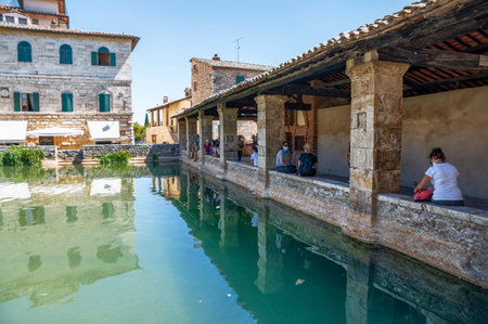 Bagno Vignoni, Tuscany, Italy. August 2020. A large natural outdoor thermal hot water pool is point of interest for tourists.のeditorial素材