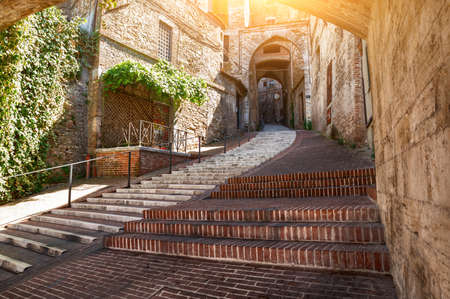 Perugia, Umbria, Italy. August 2021. Amazing view in the historic center: the ancient aqueduct is a magnificent promenade overlooked by the colorful houses. Beautiful summer day.の写真素材