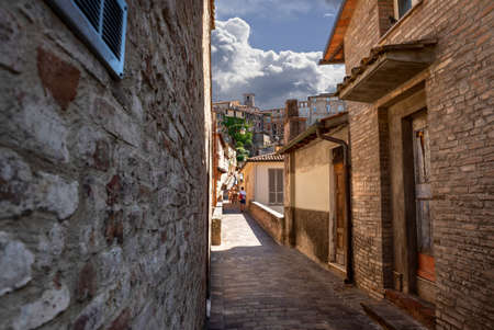 Perugia, Umbria, Italy. August 2021. Amazing view in the historic center: the ancient aqueduct is a magnificent promenade overlooked by the colorful houses. Beautiful summer day. Peopleのeditorial素材