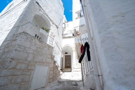 Ostuni, Puglia, Italy. August 2021. Amazing view on one of the white alleys of the old town. The unique charm of the place, white as the dominant color, the sense of peace and tranquility.の写真素材