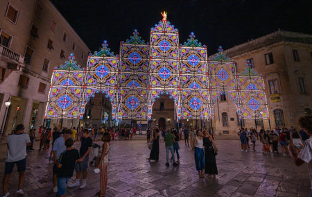 Lecce, Puglia, Italy. August 2021. On the occasion of the feast of the patron saint, Sant'Oronzo, splendid luminous decorations are installed in the historic center. People observe and photograph themのeditorial素材