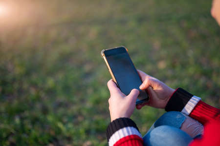 Close up shot on the smartphone screen as a young woman's fingers are typing messages. Copy space.の写真素材