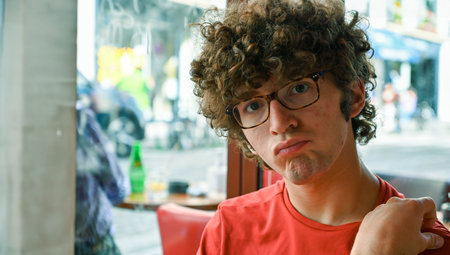 Cute Caucasian boy pouts looking into the camera.の写真素材