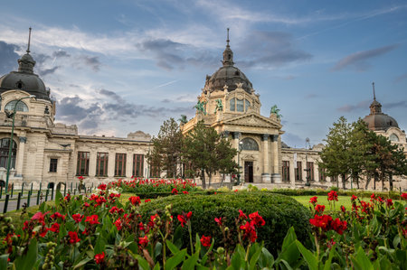 Budapest, Hungary. August 27, 2022. Shot at the entrance to the SzÃ©chenyi baths, the largest. The gardens with flowers frame the beautiful architectural complex. Travel destinations.の写真素材