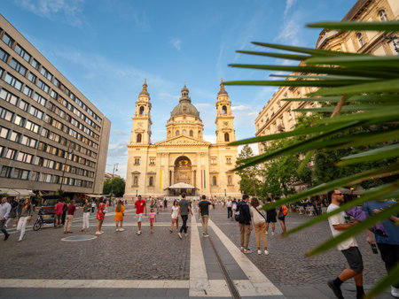 Budapest, Hungary, August 29, 2022. St. Stephen's Basilica illuminated by the warm light of late afternoon, people in the square. Travel destinations.の写真素材