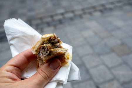Nuremberg, Germany, August 1, 2023. Close-up shot of a Nuremberg sausage sandwich, a local specialty. Relax while enjoying the typical food. Blurred background with copy space.の写真素材