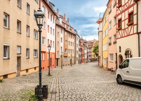 Nuremberg, Germany, 1 August 2023. The tanners' street: it has all the charm of the ancient city with the facades of the colorful and half-timbered houses. People walk along the stone-lined street.の写真素材