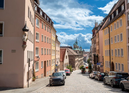 Nuremberg, Germany, August 1, 2023. On a beautiful summer day people walk in the old town. Perspective view from the hill towards the valley. Travel destinations.の写真素材