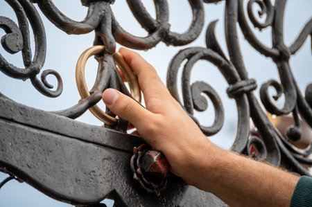 Nuremberg, Germany, August 2, 2023. Detail shot of the fountain in the market square. The golden ring embedded in the railing is considered a lucky charm if rotated. The hand rotates it.の写真素材