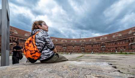 Nuremberg, Germany, August 3, 2023. View inside the abandoned Nazi Congress Hall building. Two young men observe the site and information panels. Travel destinations.の写真素材