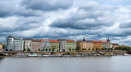 Prague, Czech Republic, August 7, 2023. Panoramic shot of the Dancing House along the Vltava River: futuristic shapes and modern materials alongside colorful historic buildings. Travel destinations.の写真素材