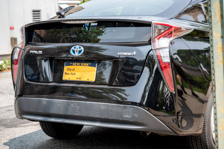 New york, usa august 16,2024. Toyota prius hybrid with new york city government license plate parked on a nyc street, rear view emphasizing eco friendly urban transport
