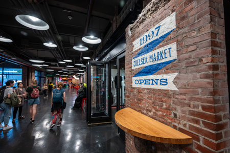 New york, usa august 20,2024. People strolling and shopping inside chelsea market, the bustling historic manhattan food hall and renovated factory landmark in nyc