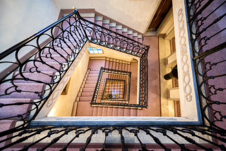 ramp and stairs that turns, seen from above, inside a building