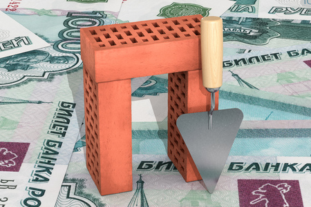 3d illustration: red silicate bricks stacked in a pile with a tool for laying mortar - trowel Isolated on rouble banknotes background. Business metaphor concept: planning and construction of housing. の写真素材