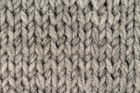 Gray knitting wool texture background. Macro