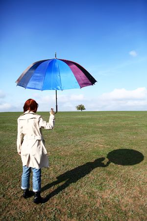Girl  with umbrella at country sideの写真素材