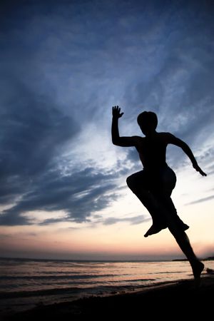 Runner on the beach at sunsetの写真素材