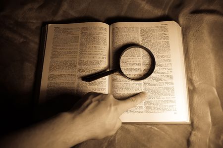 view through loupe at bookの写真素材