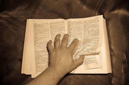 Hand over book squeezing book's pageの写真素材