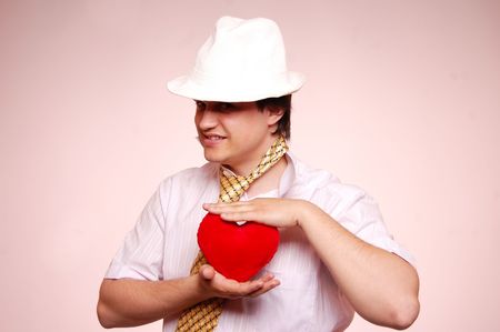 boy with heart in white capの写真素材