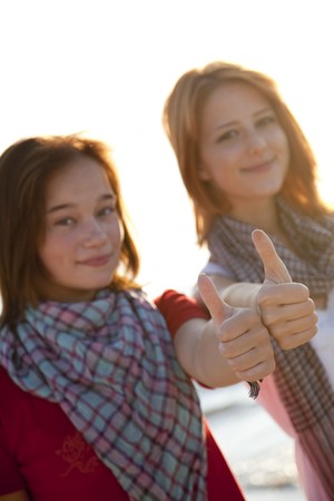 Two beautiful girls show OK の写真素材