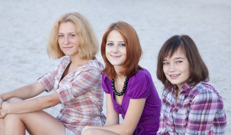 Portrait of three beautiful girls on the beach.の写真素材