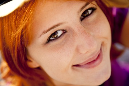 Close-up portrait of beautiful red-haired girl. Focus on eyes.の写真素材