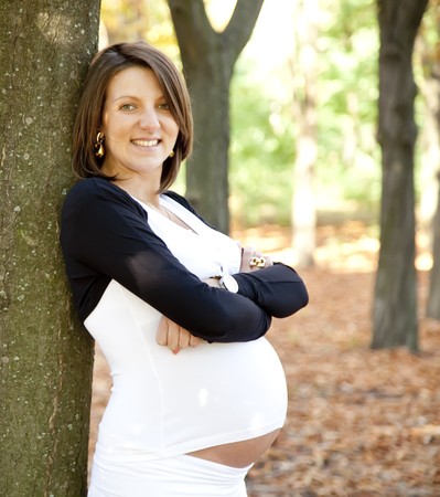 Beautiful expectant girl in the park.の写真素材