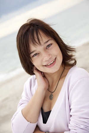 Portrait of beautiful brunet girl on the beach.の写真素材