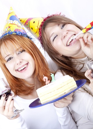 Two girlfriends with cake and wine celebrate 21th birthdayの写真素材