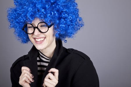 Funny blue-hair girl in glasses and black coat. Studio shot.の写真素材