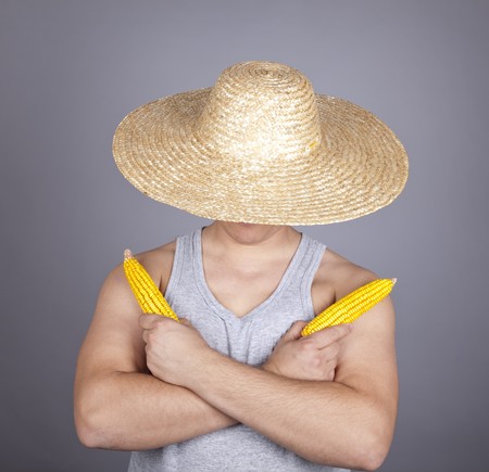 Aggressive farmer show two corns. Studio shot.の写真素材