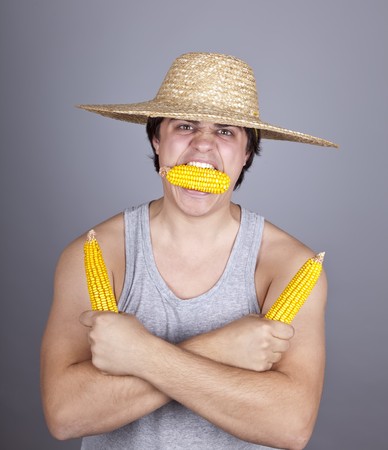 Aggressive farmer show three corns. Studio shot.の写真素材