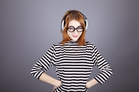 Funny girl with headphone and glasses. Studio shot.の写真素材