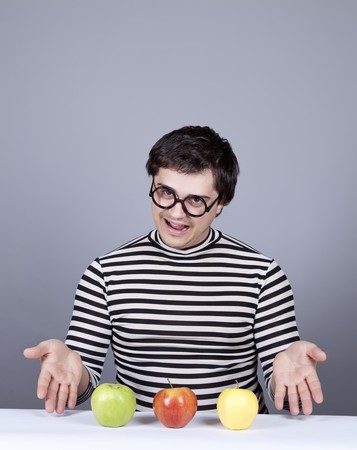Funny boy show to eat apples. Studio shot.の写真素材