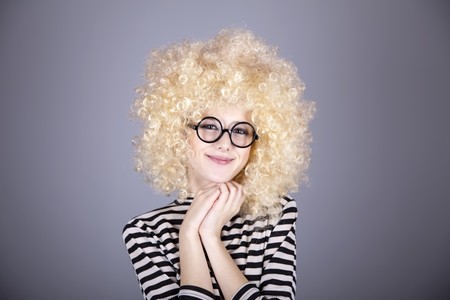 Portrait of funny girl in blonde wig. Studio shot.の写真素材
