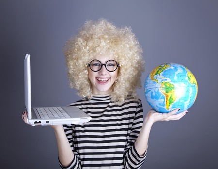 Funny girl in glasses keeping notebook and globe. Studio shot.の写真素材