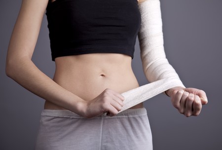 Strong girl's body with with elastic bandage on hand. Studio shot.の写真素材