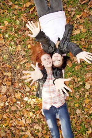 Two girlfriends at the autumn park. Outdoor shot.の写真素材