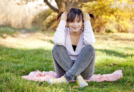 Beautiful brunette girl at the park. Outdoor shot.の写真素材