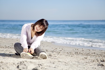 Portrait of brunette girl at the beach. Outdoor shot.の写真素材