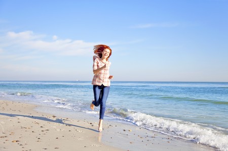 Running girl at the beach. の写真素材