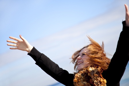Red-haired girl in action. Outdoor shot.の写真素材