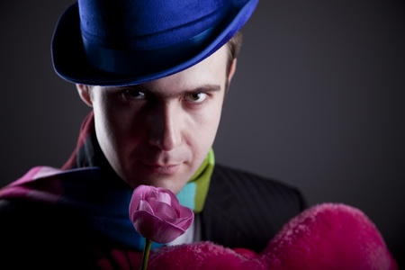 Mysterious men with toy and roseの写真素材