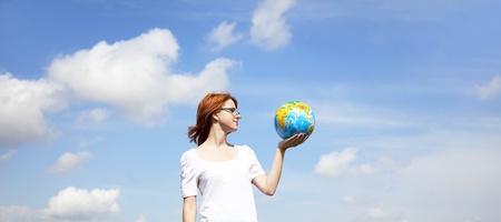 Young Businesswomen in white keeping globe in handの写真素材