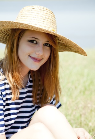 Beautiful redhead girl at countryside nead lake.の写真素材