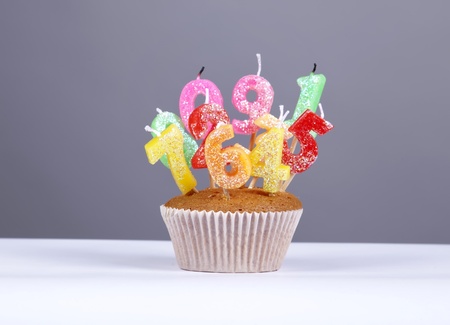 Cake with candles at studio isolated.の写真素材